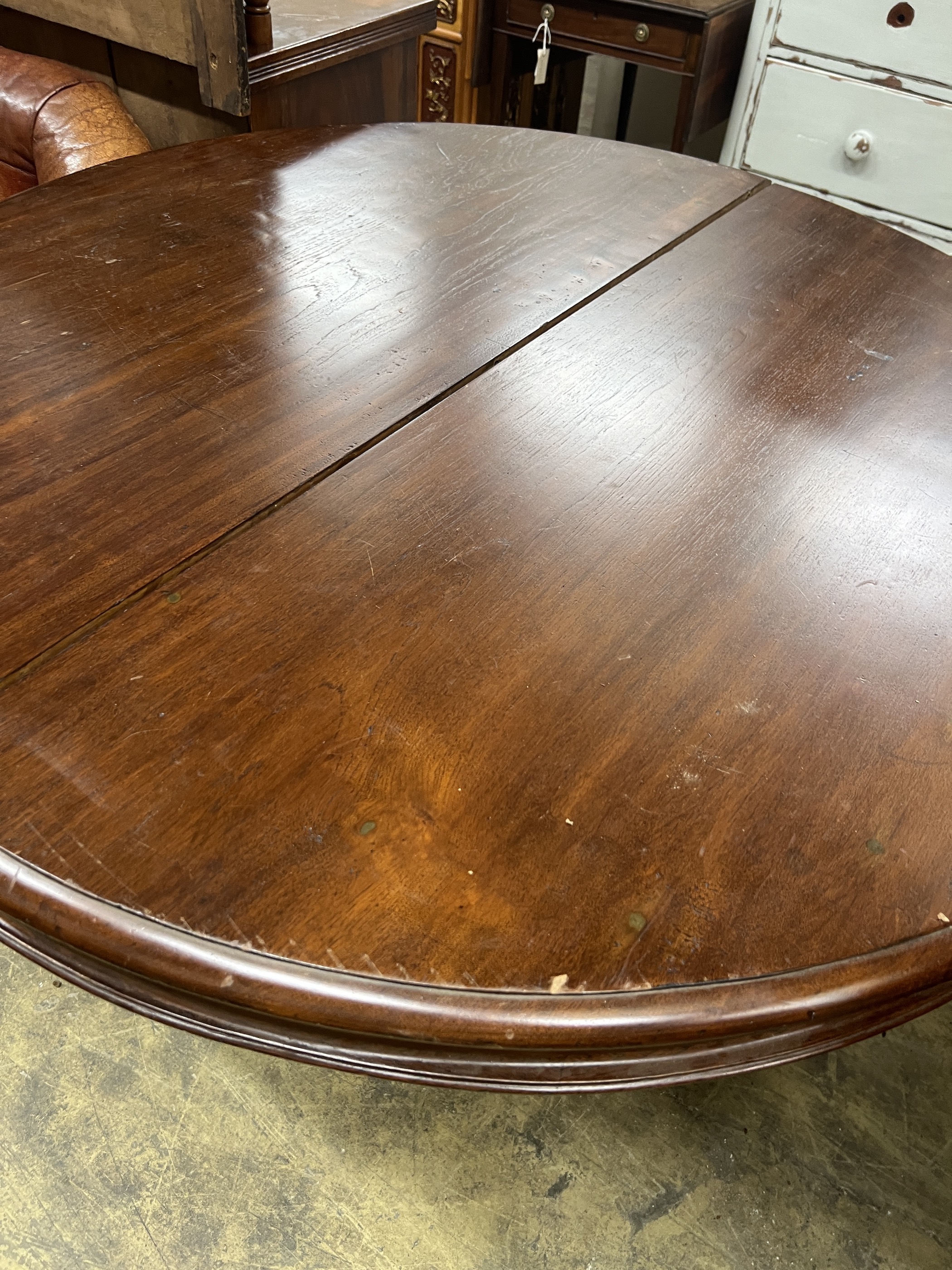 A 19th century and later Continental mahogany circular extending dining table, length approx. 270cm extended, three spare leaves, width 122cm, height 76cm